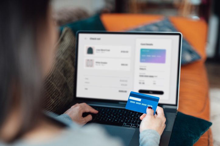 Photo of woman using credit card for online shopping